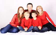 color photo of family group in red shirts